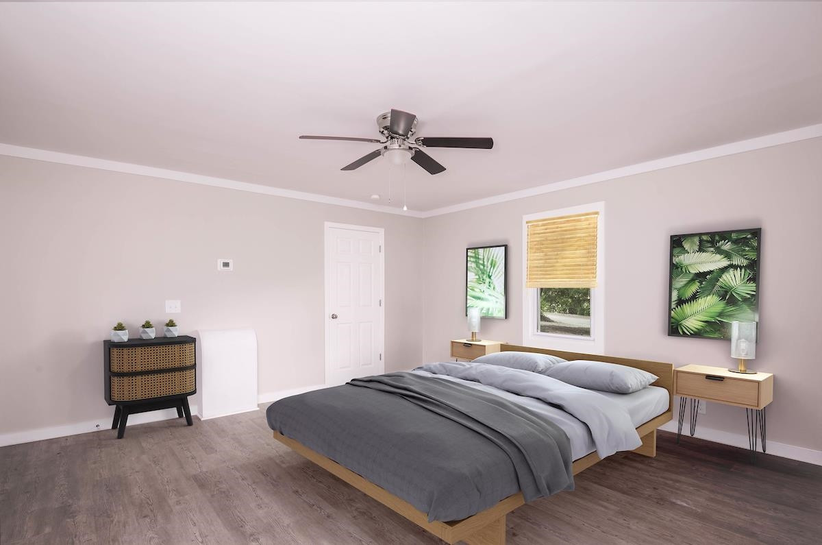 314 Depot Street Roxboro, NC 27573 - Photo 28 of 35 a bedroom with a bed and a chandelier