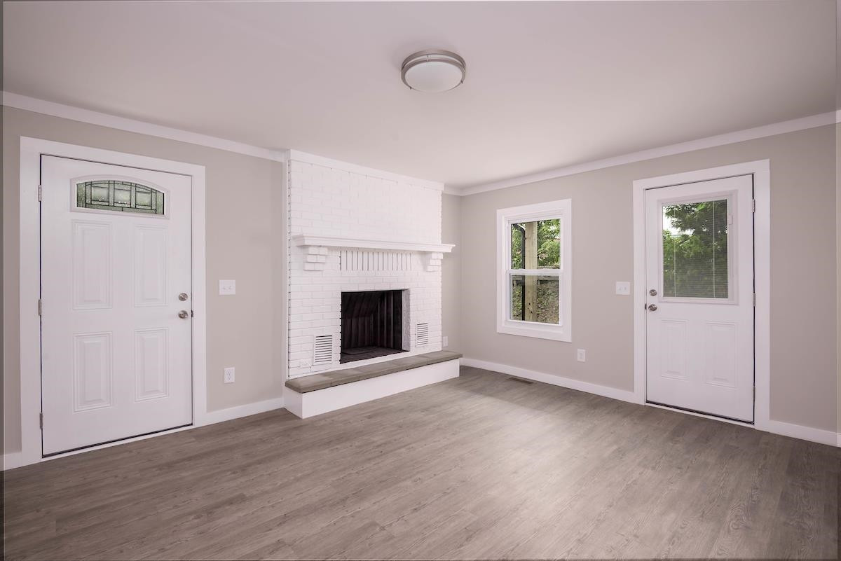 314 Depot Street Roxboro, NC 27573 - Photo 5 of 35 a view of an empty room with wooden floor and a window