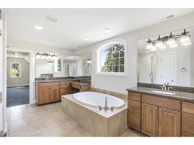 a bathroom with a granite countertop sink mirror and