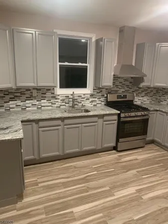 a kitchen with stainless steel appliances granite countertop a stove and a sink