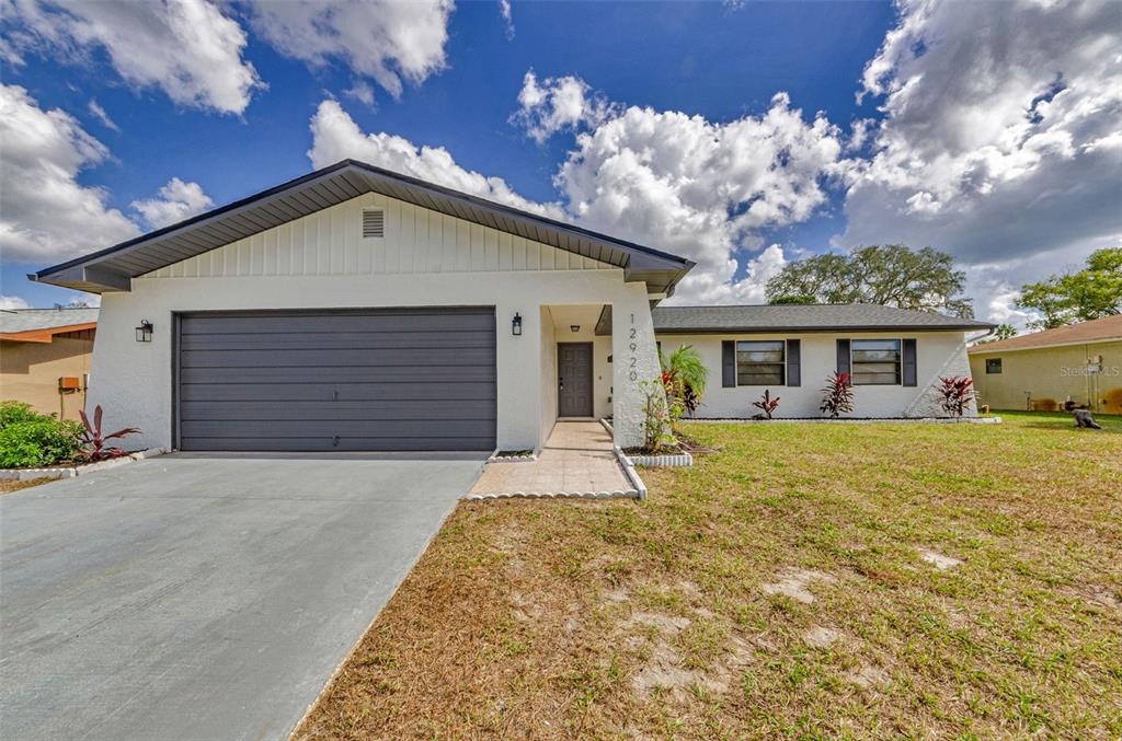 12920 Walnut Tree Lane Hudson, FL 34669 - Photo 1 of 35 front view of a house with a yard