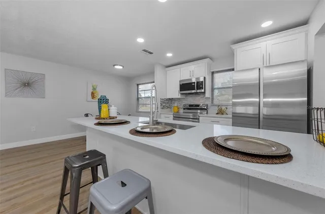 a kitchen with sink refrigerator and stove