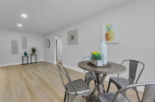 a view of a dining room with furniture and wooden floor