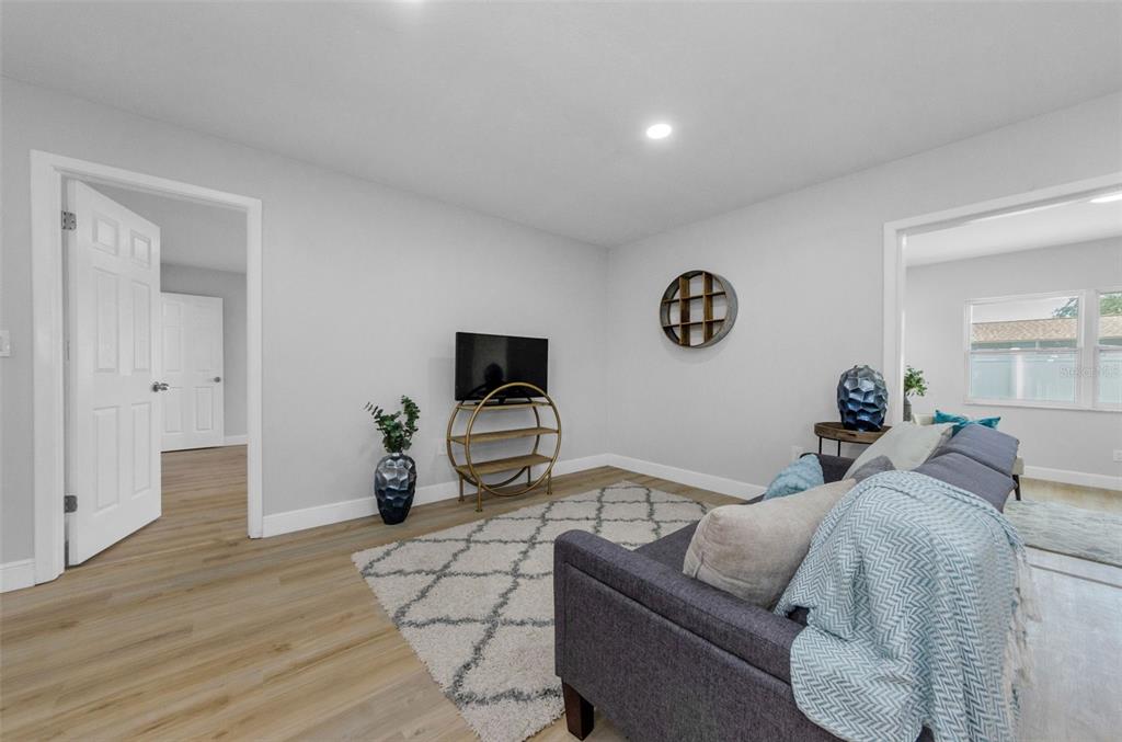 12920 Walnut Tree Lane Hudson, FL 34669 - Photo 18 of 35 a living room with furniture and a flat screen tv