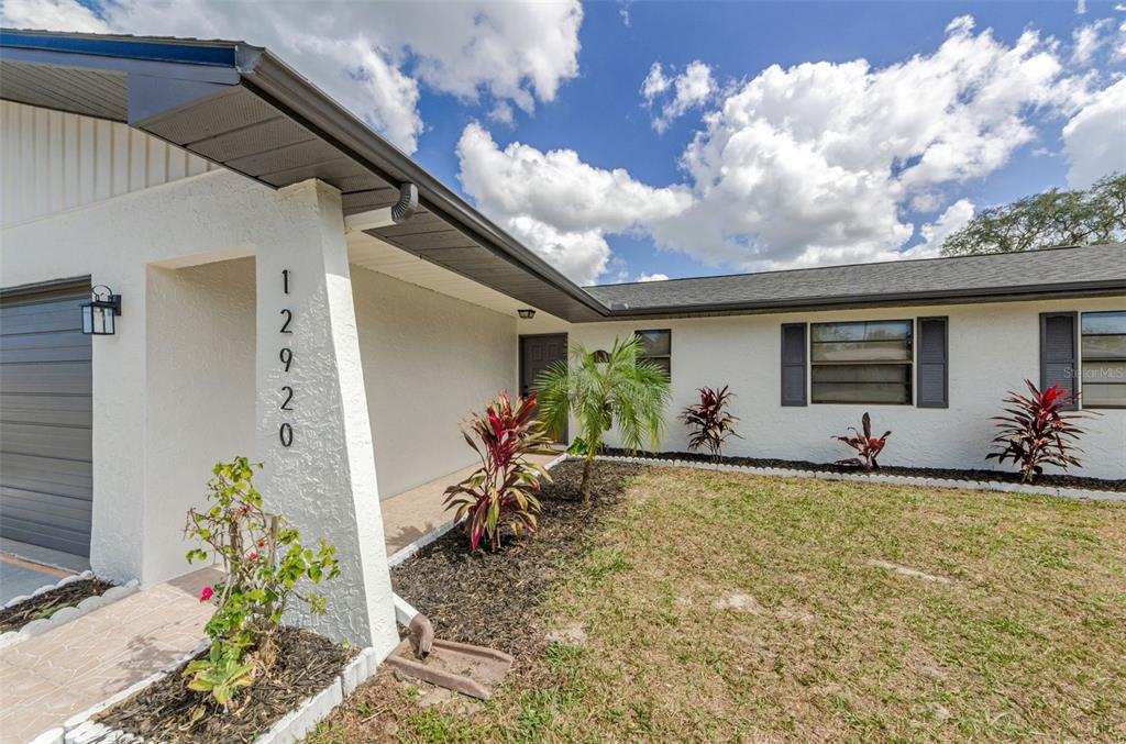 12920 Walnut Tree Lane Hudson, FL 34669 - Photo 2 of 35 a view of a house with backyard and sitting area