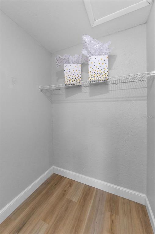 12920 Walnut Tree Lane Hudson, FL 34669 - Photo 25 of 35 a view of an empty room with wooden floor and a window