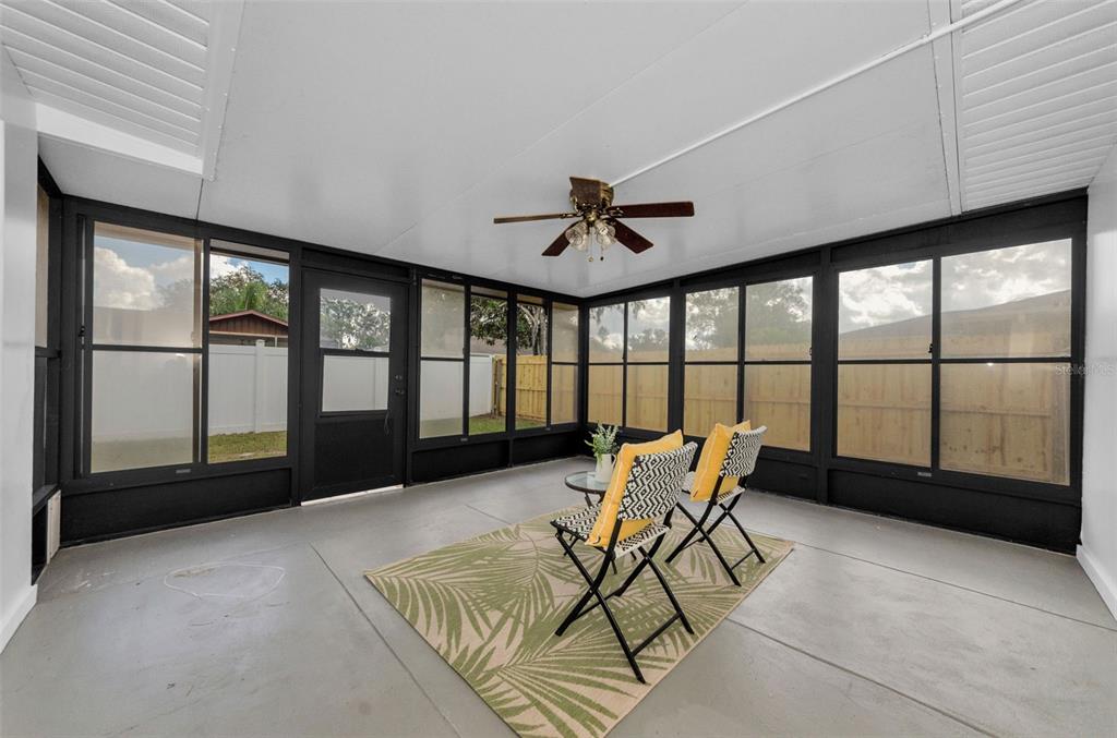 12920 Walnut Tree Lane Hudson, FL 34669 - Photo 30 of 35 a living room with furniture and a large window
