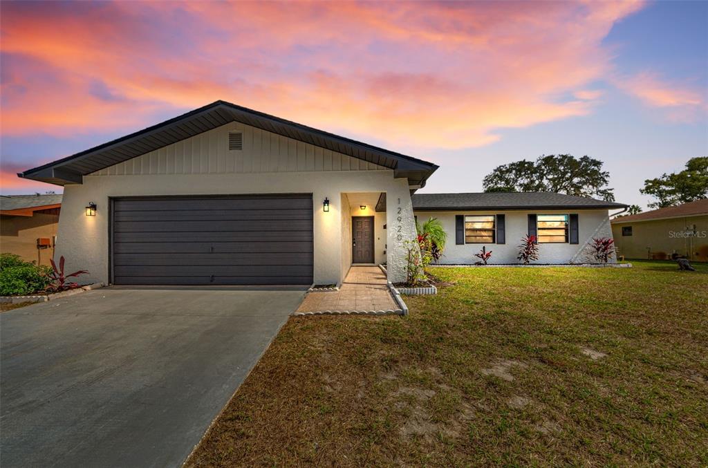 12920 Walnut Tree Lane Hudson, FL 34669 - Photo 3 of 35 front view of a house with a yard