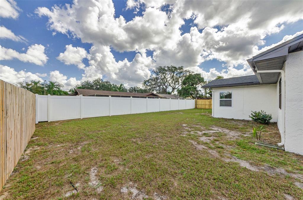 12920 Walnut Tree Lane Hudson, FL 34669 - Photo 34 of 35 a view of a backyard with a large tree