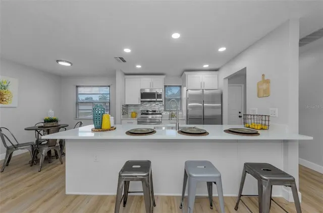 a kitchen with stainless steel appliances a sink and cabinets