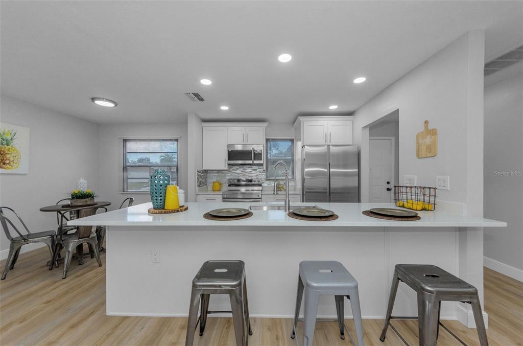 12920 Walnut Tree Lane Hudson, FL 34669 - Photo 7 of 35 a kitchen with stainless steel appliances a sink and cabinets