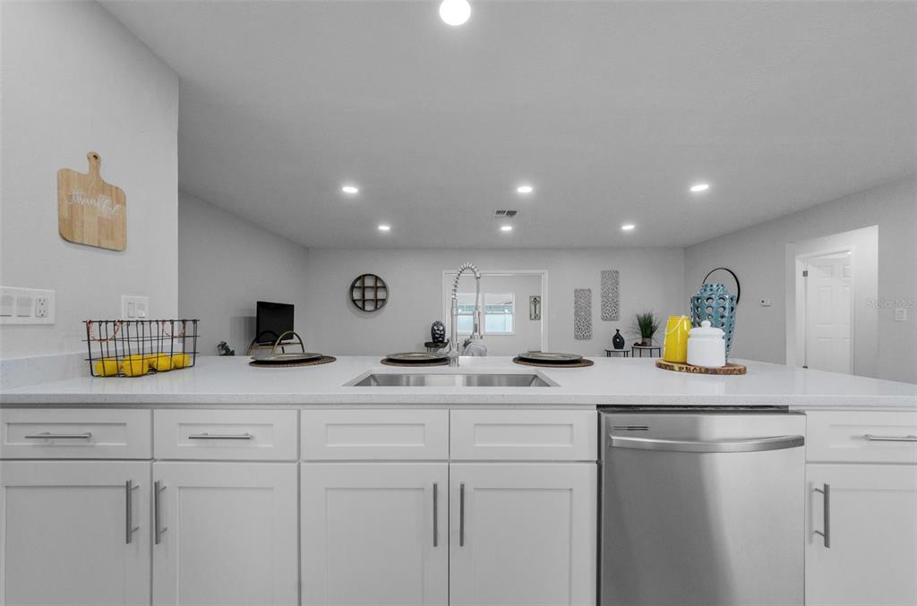 12920 Walnut Tree Lane Hudson, FL 34669 - Photo 8 of 35 a kitchen with counter top space cabinets and appliances