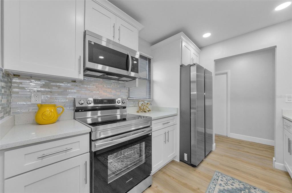 12920 Walnut Tree Lane Hudson, FL 34669 - Photo 9 of 35 a kitchen with a sink and a stove top oven