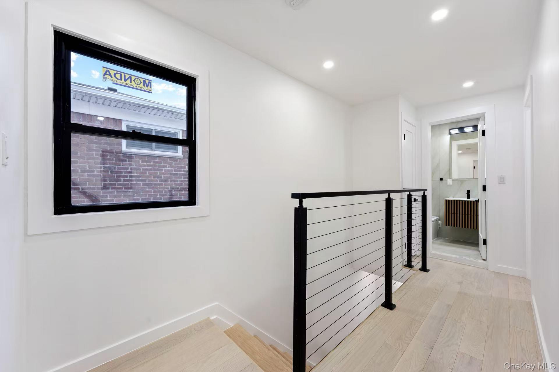 157-03 Locke Avenue Queens, NY 11357 - Photo 12 of 24 a view of entryway with stairs and a window