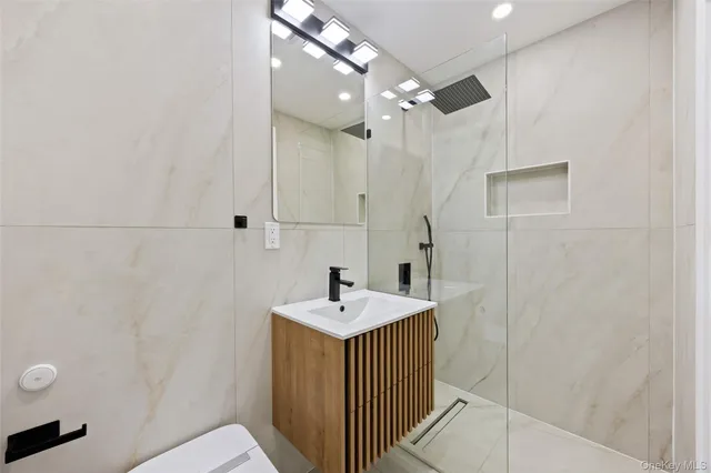 a bathroom with a sink a mirror and shower