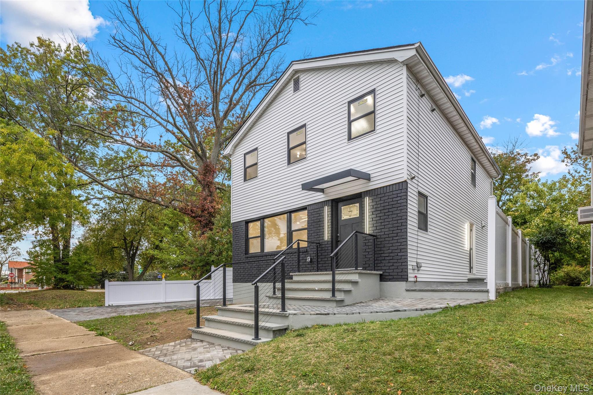 157-03 Locke Avenue Queens, NY 11357 - Photo 2 of 24 a front view of a house with a yard