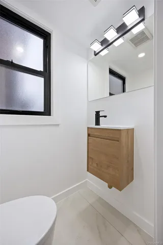 a bathroom with a bathtub sink vanity and mirror