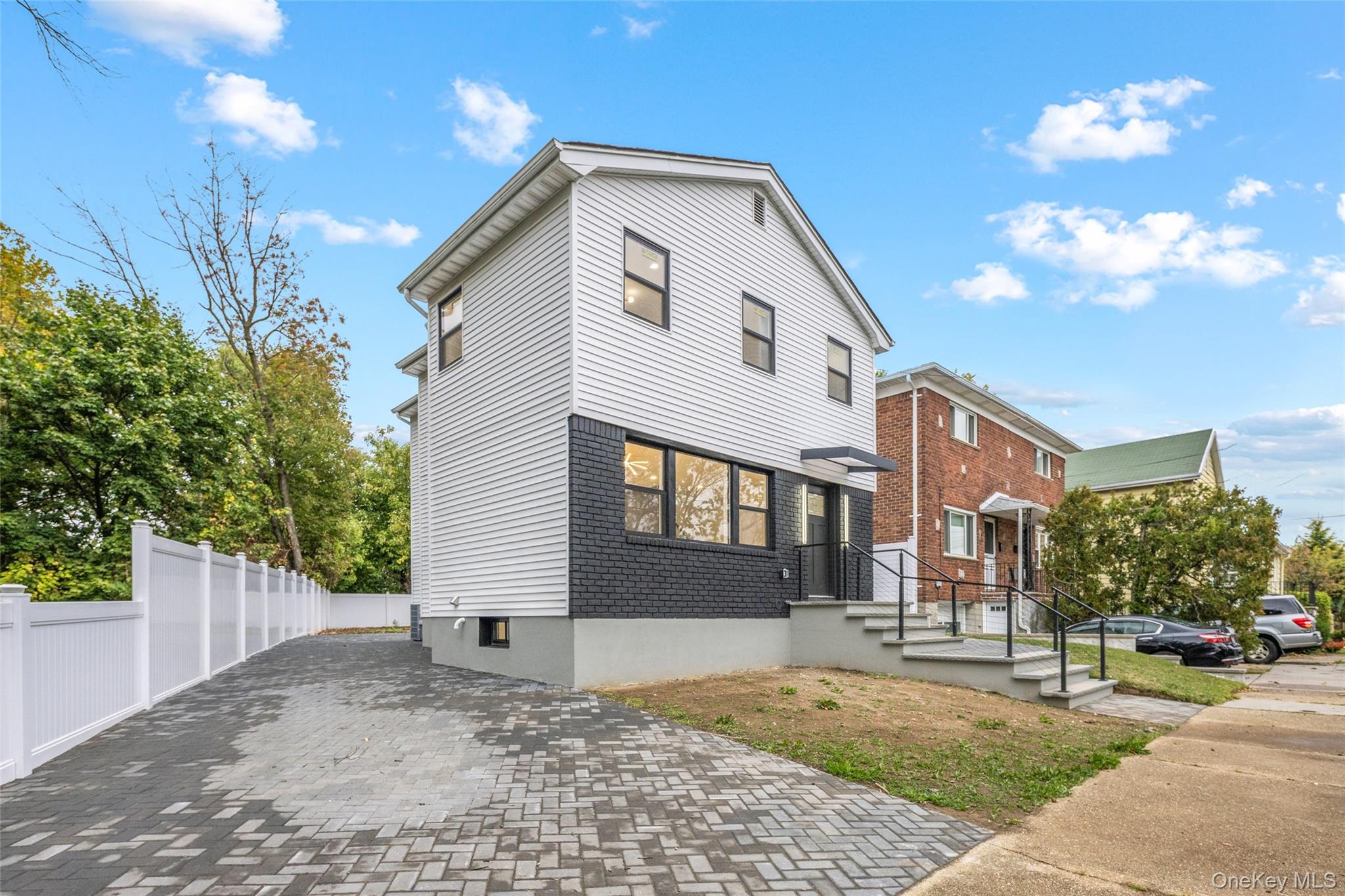 157-03 Locke Avenue Queens, NY 11357 - Photo 3 of 24 a front view of a house with a yard