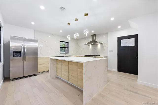 a large kitchen with a refrigerator and a sink