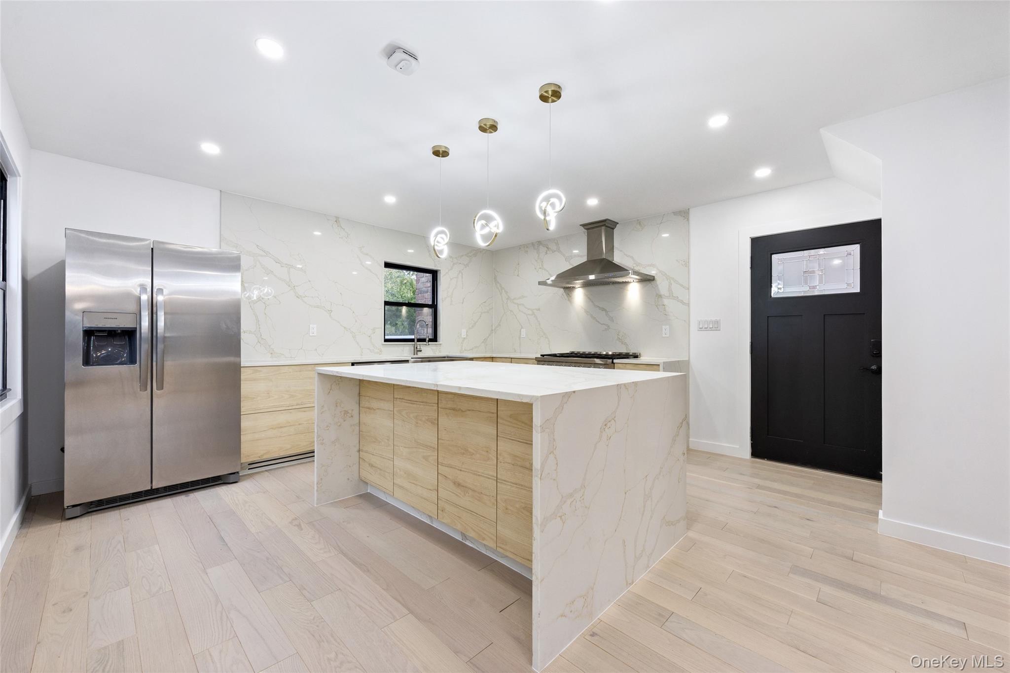 157-03 Locke Avenue Queens, NY 11357 - Photo 4 of 24 a large kitchen with a refrigerator and a sink