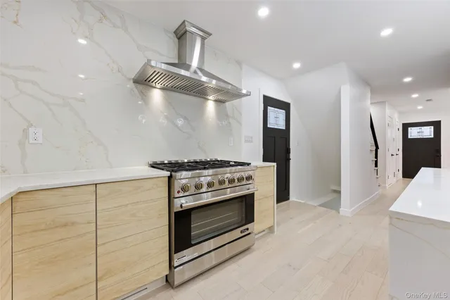 a stove top oven sitting inside of a kitchen
