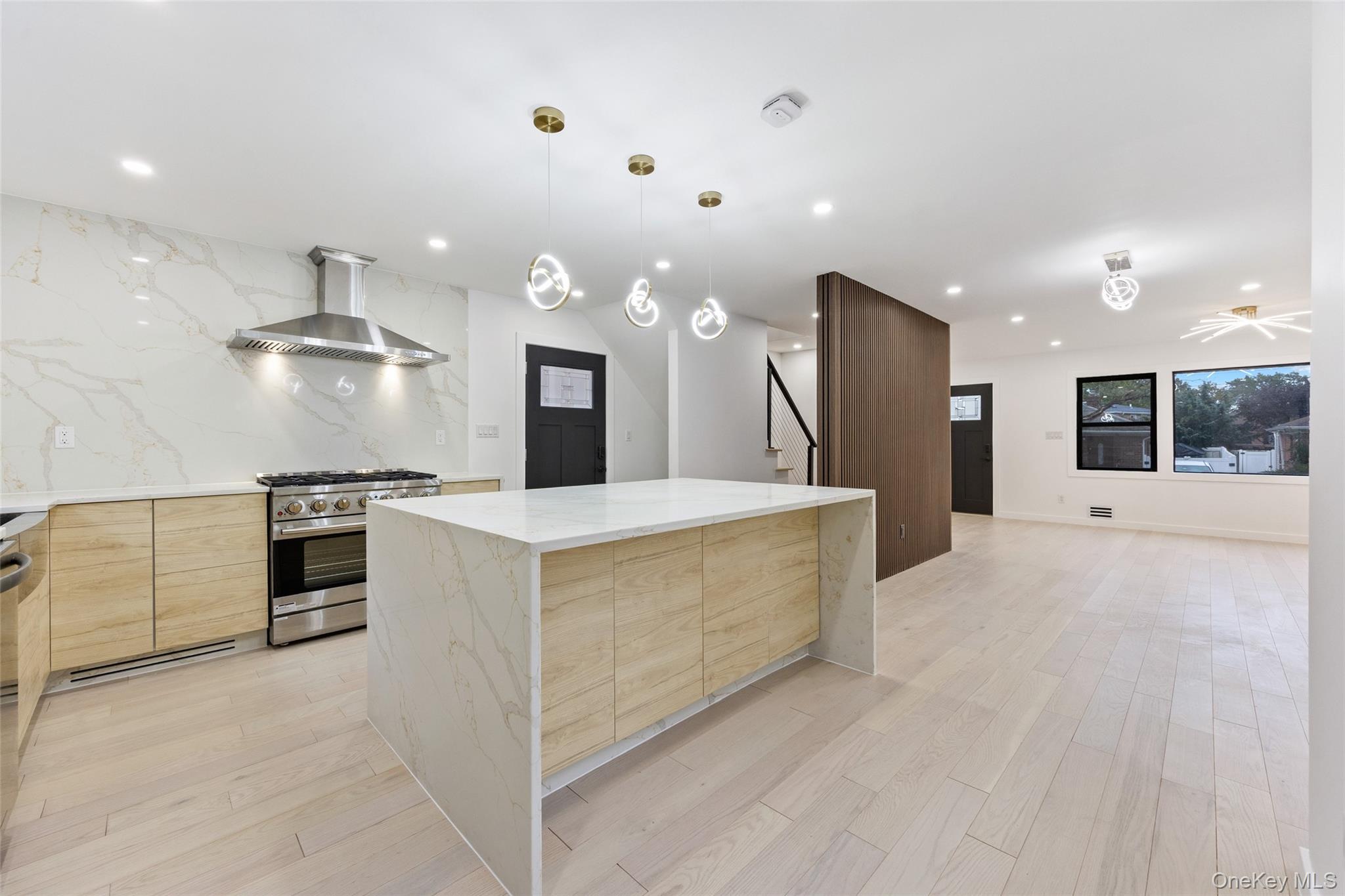 157-03 Locke Avenue Queens, NY 11357 - Photo 6 of 24 a large kitchen with stainless steel appliances kitchen island a large counter top and oven