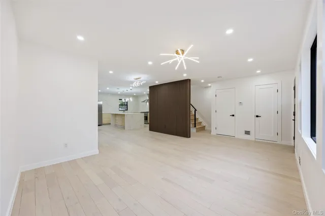 a view of a kitchen with a refrigerator and a sink