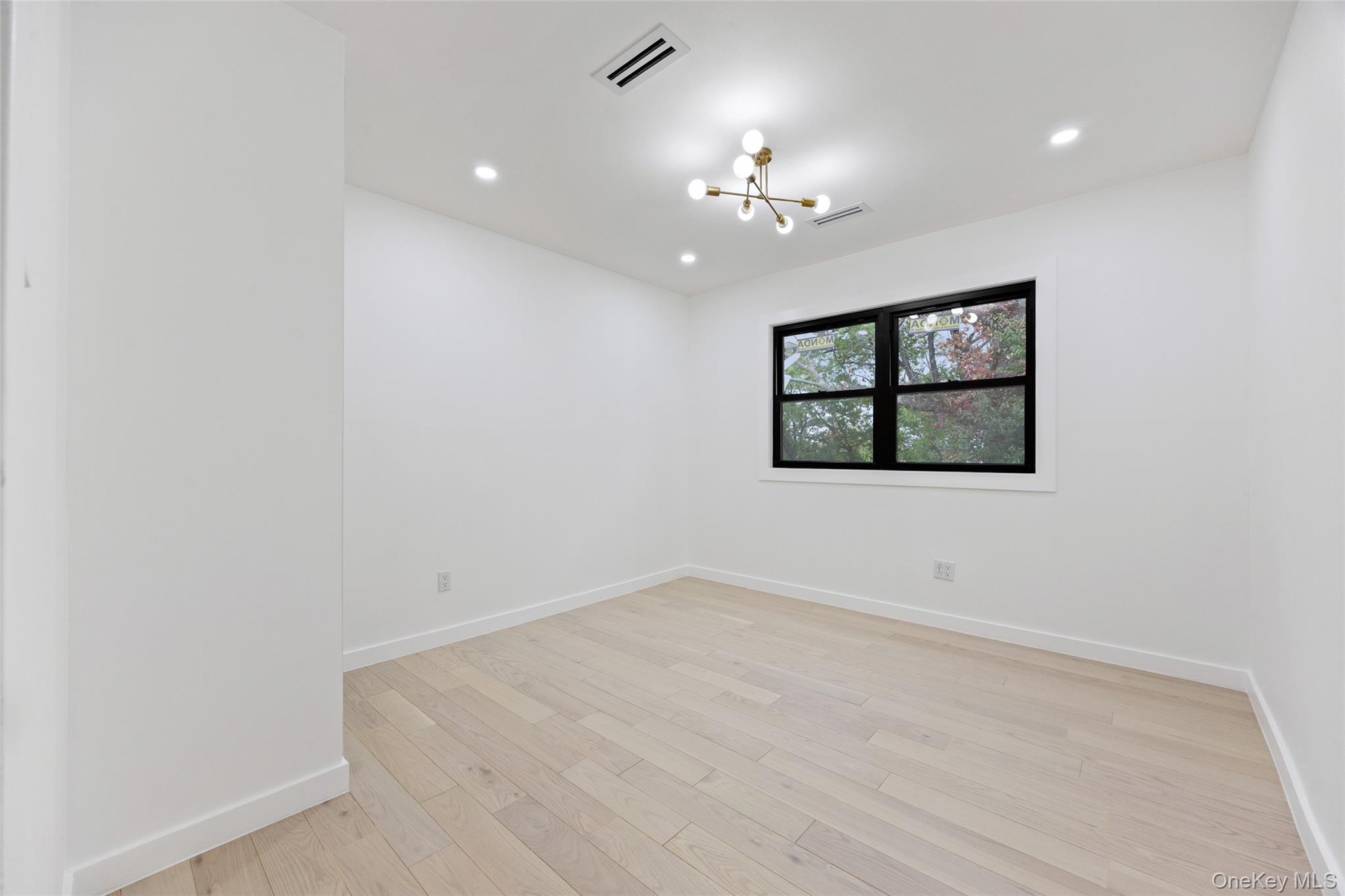 157-03 Locke Avenue Queens, NY 11357 - Photo 10 of 24 wooden floor in an empty room with a window