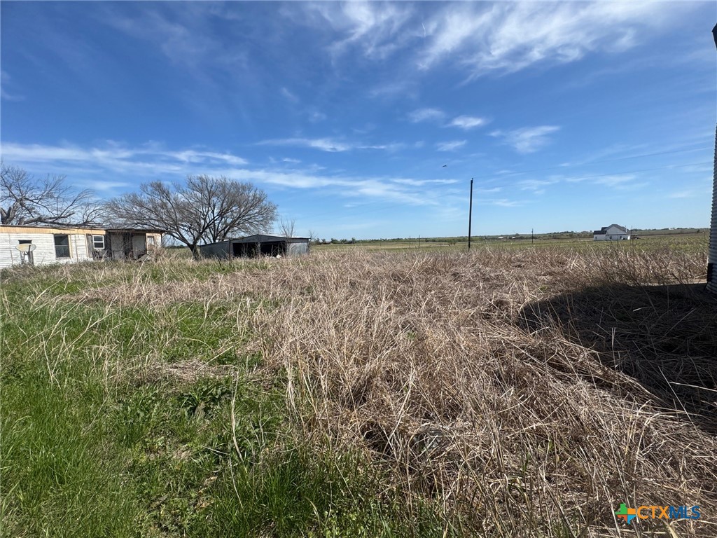 224 5th Street Burlington, TX 76519 - Photo 5 of 8 a view of a dry yard with wooden fence