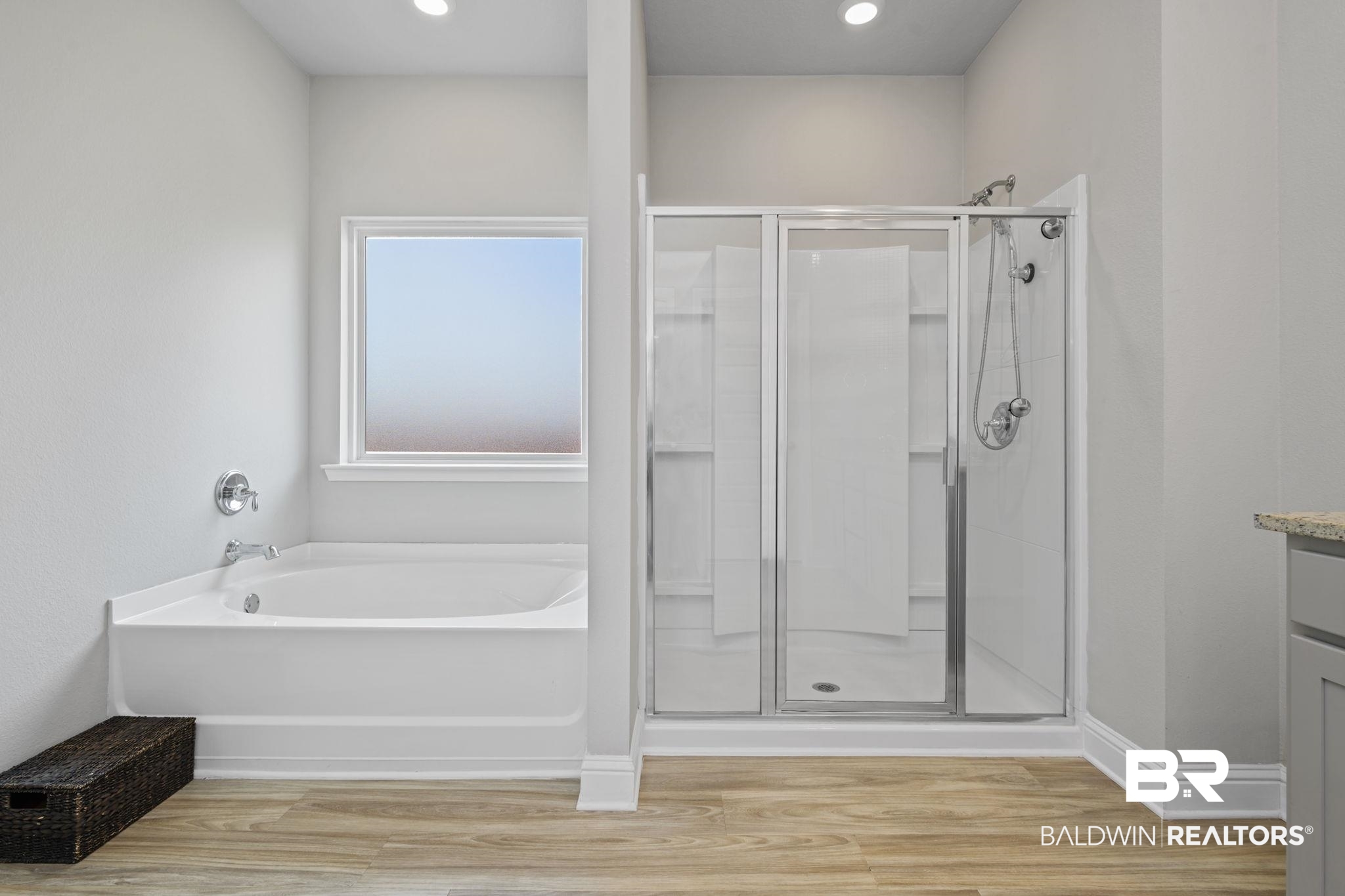 2183 Meadowview Loop Semmes, AL 36575 - Photo 44 of 58 Full bath featuring a shower stall, light wood-type flooring, vanity, and a bath