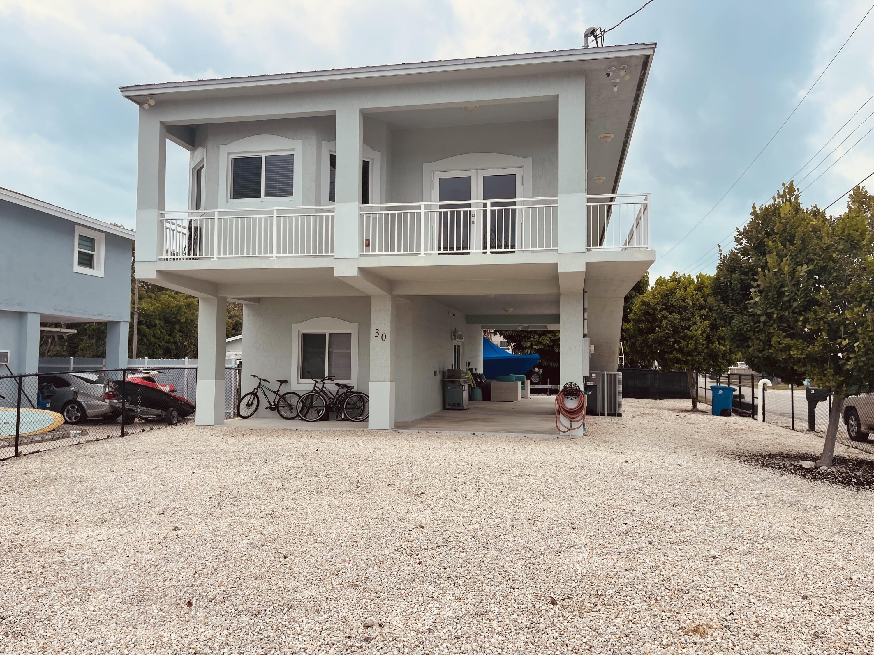 30 Coconut Drive Key Largo, FL 33037 - Photo 1 of 39 a view of a house with a large tree in front of it