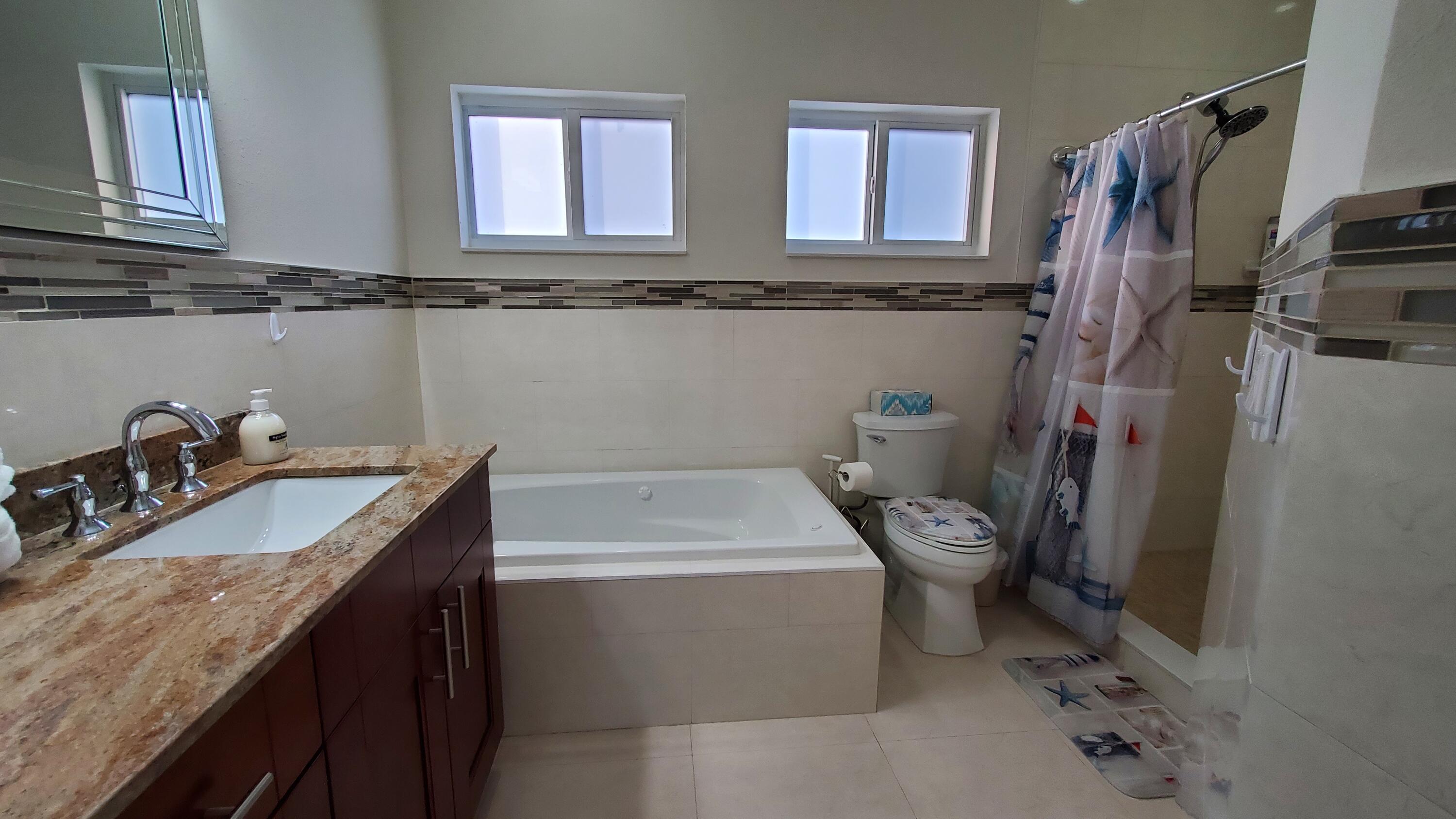 30 Coconut Drive Key Largo, FL 33037 - Photo 20 of 39 a bathroom with a sink a toilet and a window