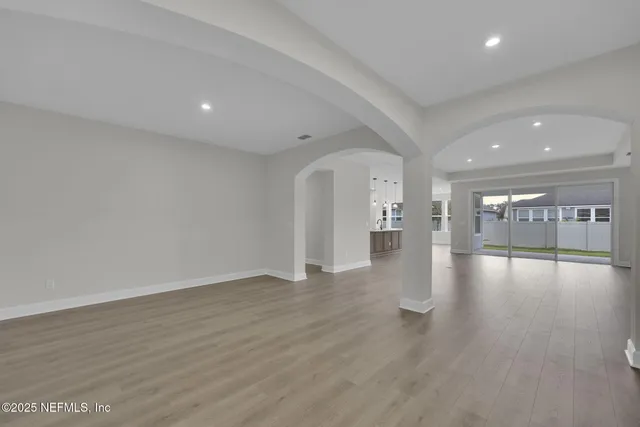 a view of a kitchen with kitchen island a sink stainless steel appliances and cabinets