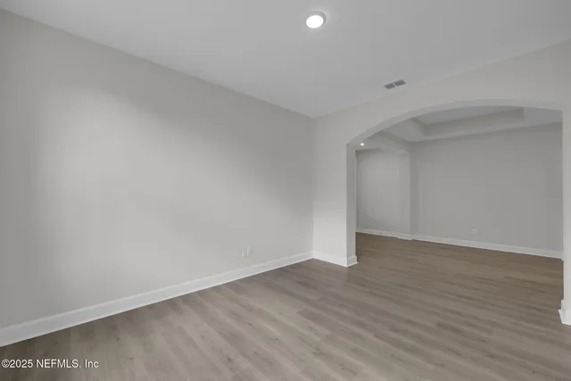 a kitchen with white cabinets and sink