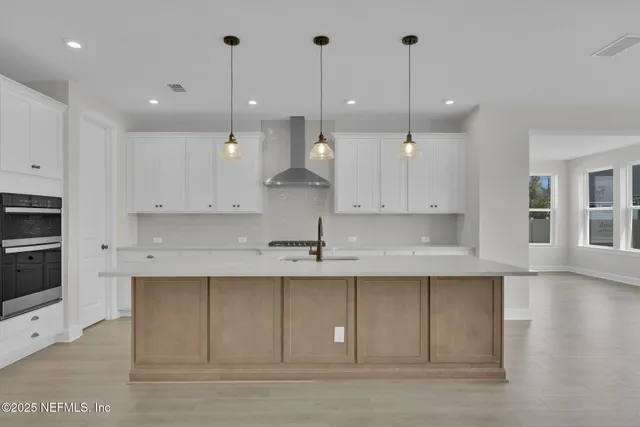 a bathroom with a double vanity sink a toilet a mirror and shower