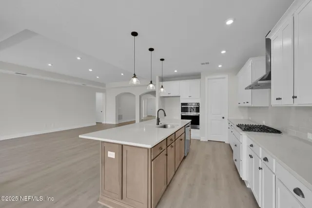 a bathroom with a bathtub shower sink and mirror