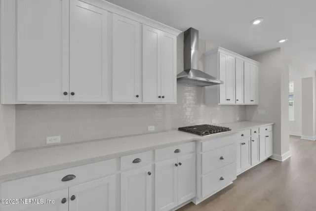 a bathroom with a double vanity sink mirror and bathtub