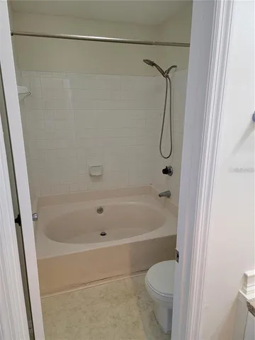 a bathroom with a shower and a toilet