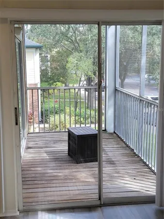 a view of a room with wooden floor and outdoor space