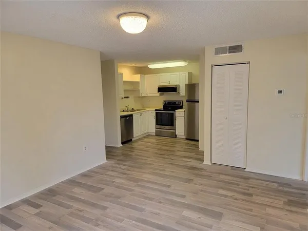 a view of a kitchen with a stove cabinets and wooden floor