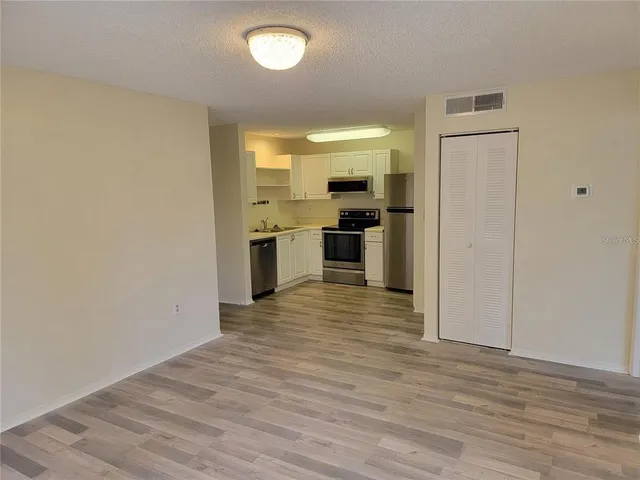 a view of a kitchen with a stove cabinets and wooden floor