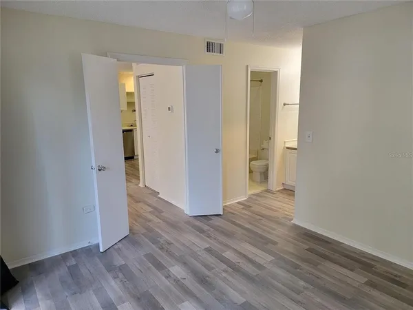 a view of a hallway with wooden floor