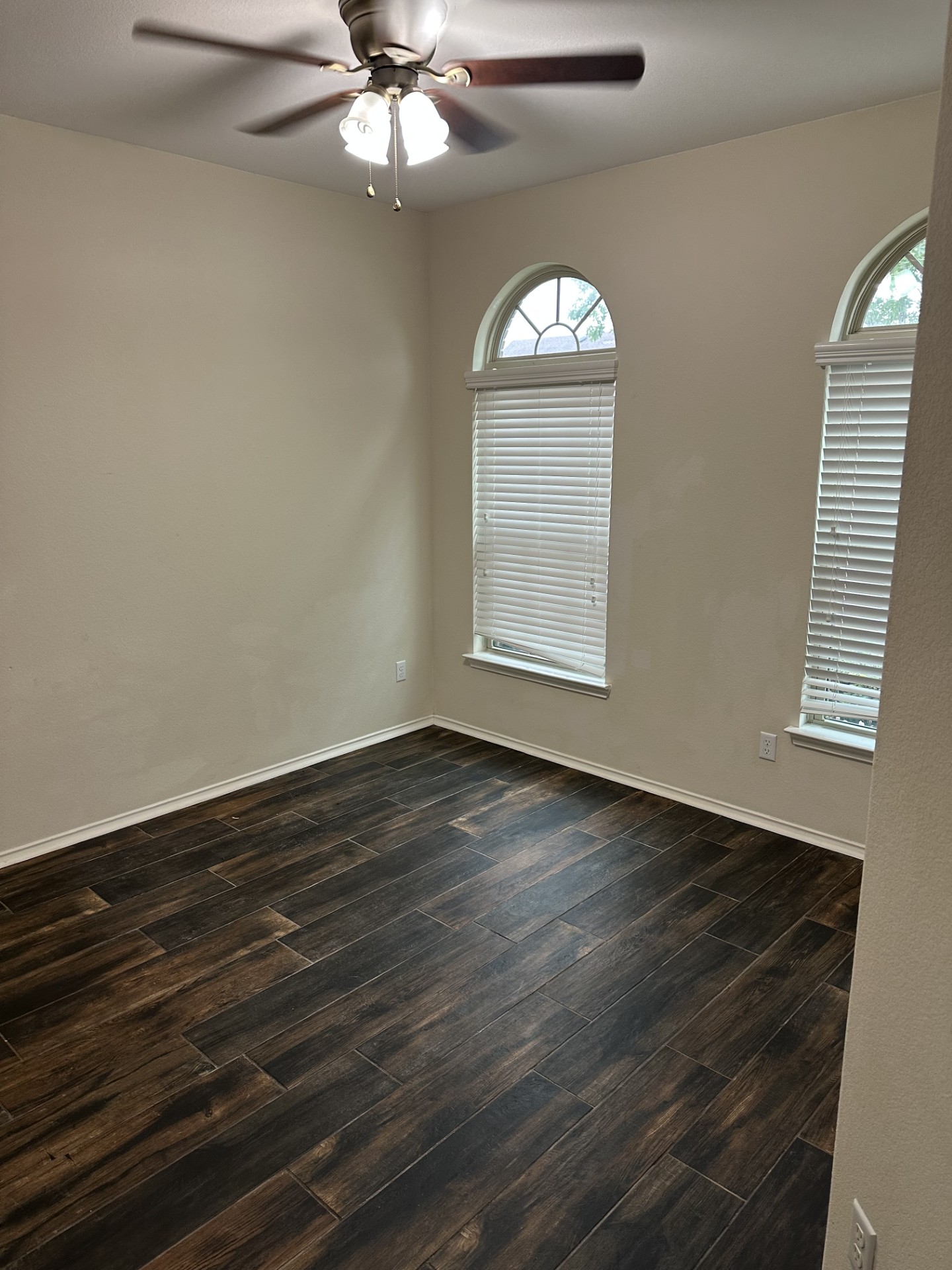 3029 Jacob Lane San Marcos, TX 78666 - Photo 7 of 24 an empty room with wooden floor fan and windows
