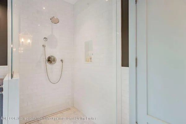 a bathroom with a glass shower door