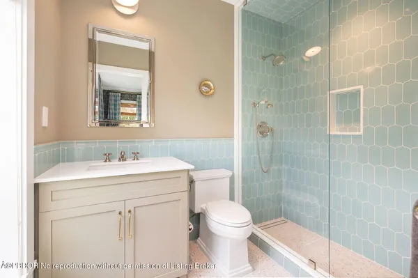 a bathroom with a sink toilet vanity and shower