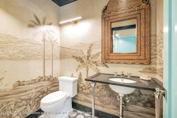 a bathroom with a toilet sink and mirror