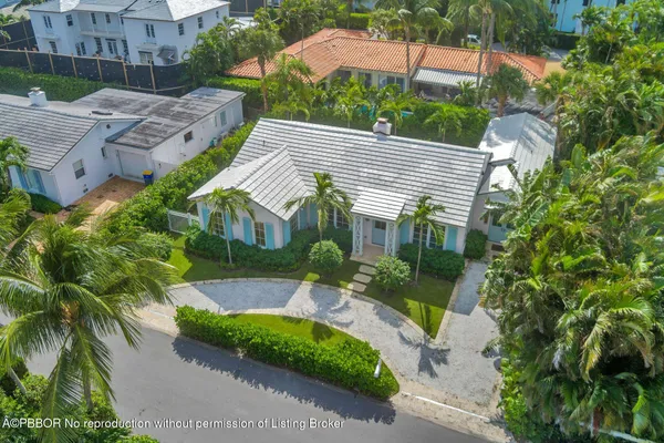 a aerial view of a house with a yard and potted plants