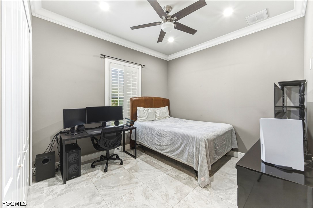 1700 43rd Terrace Southwest Naples, FL 34116 - Photo 11 of 38 a bedroom with a bed and a chair