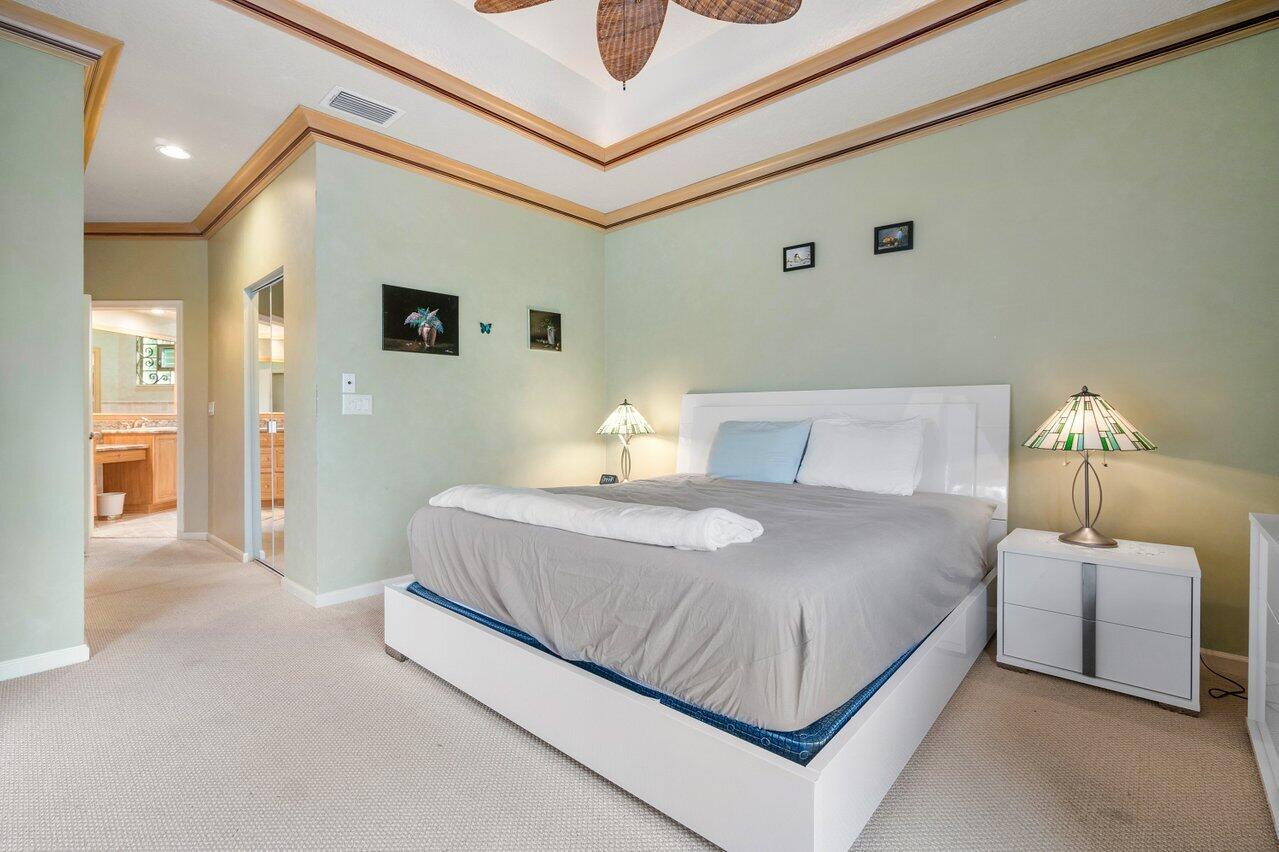 8161 Quail Meadow Way West Palm Beach, FL 33412 - Photo 12 of 36 a bedroom with a bed and a night stand
