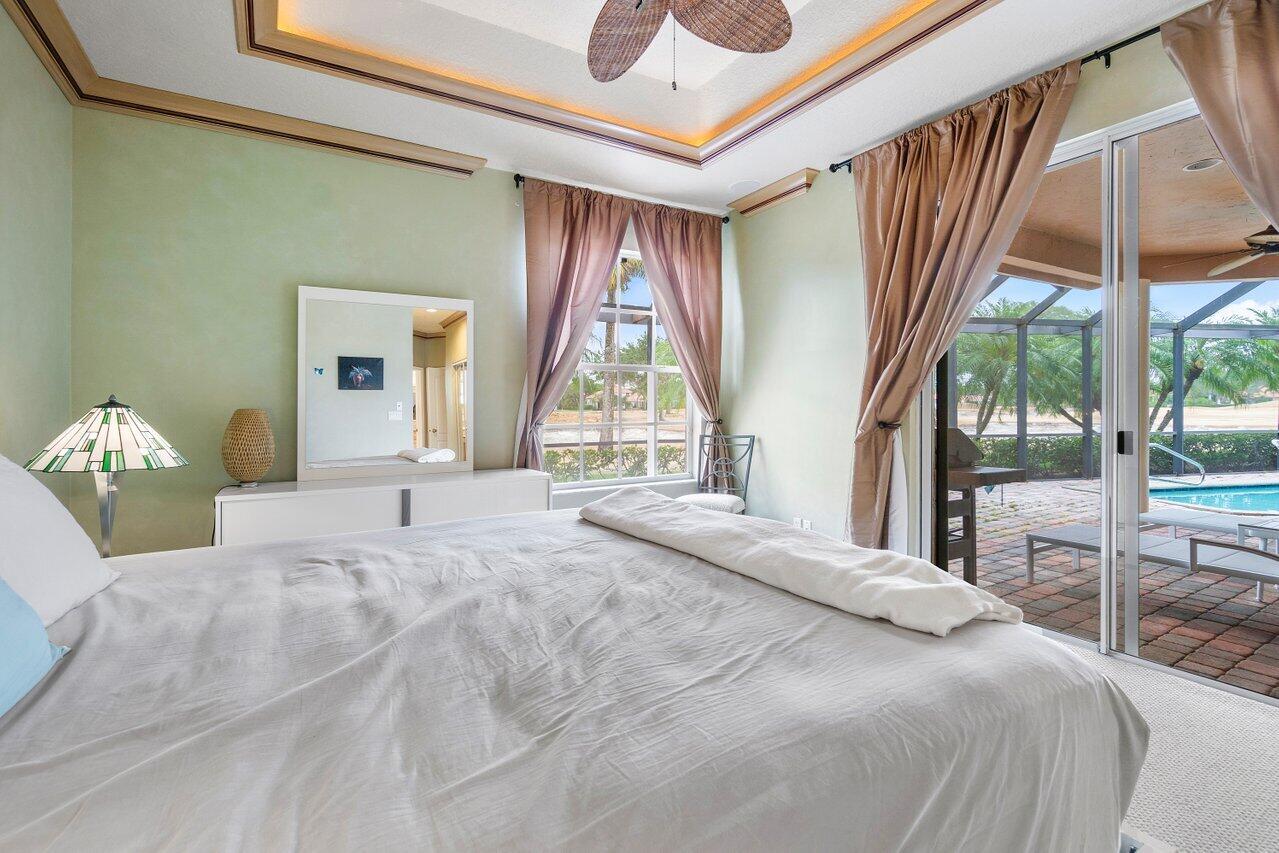 8161 Quail Meadow Way West Palm Beach, FL 33412 - Photo 13 of 36 a bedroom with a bed and a large window